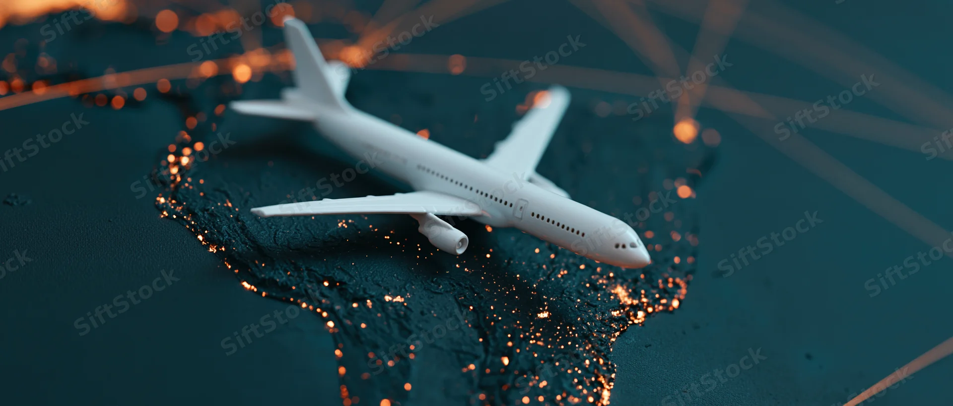 Miniature white airplane model resting on illuminated map of south america with glowing city lights and connecting lines