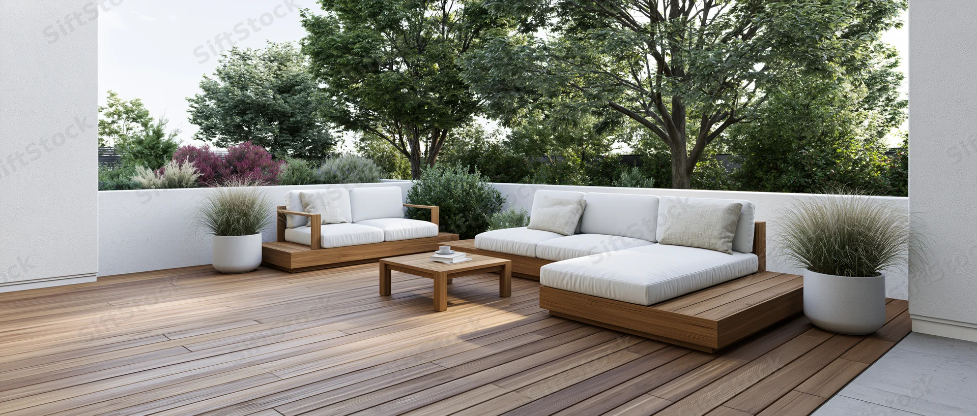 Modern outdoor patio with teak wood deck and white cushioned lounge furniture surrounded by greenery