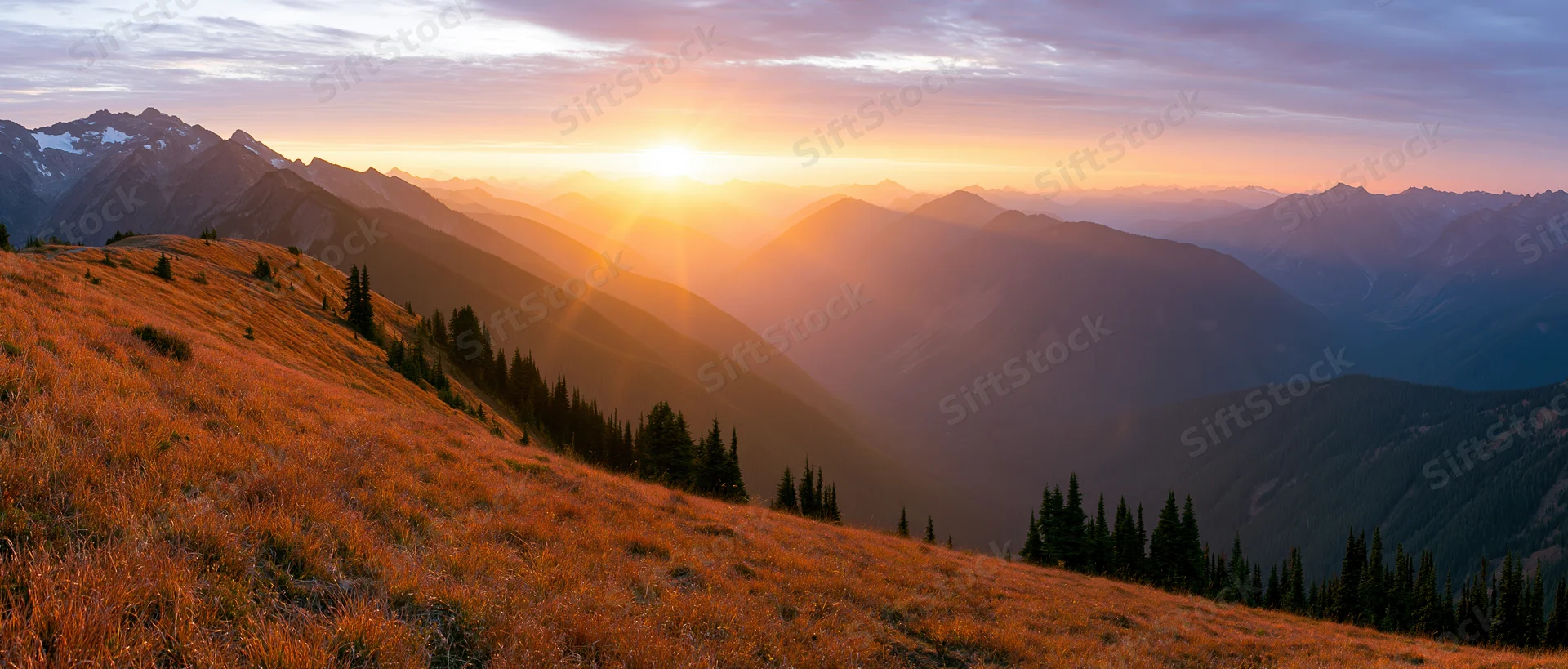 Panoramic alpine landscape at golden sunset with layered mountains and grassy slopes