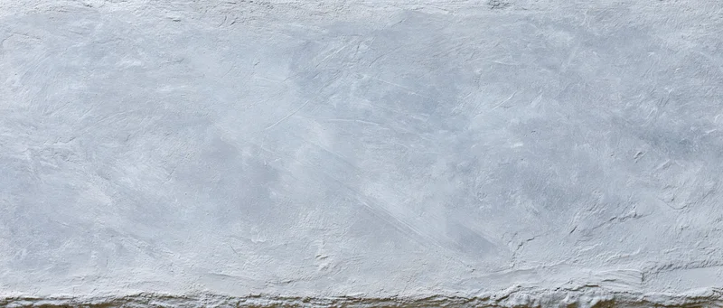 Close-up of a gray concrete wall surface with rough texture and subtle imperfections