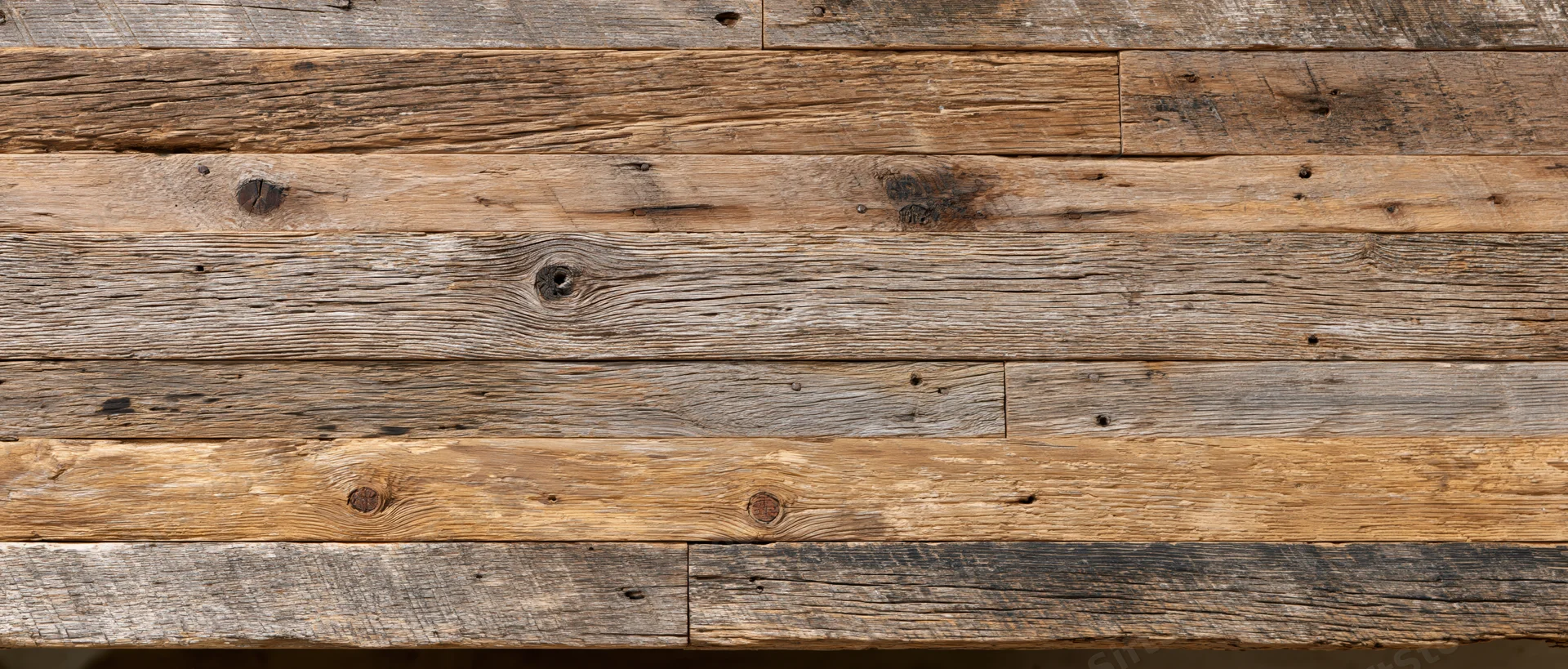 Reclaimed barn wood paneling arranged horizontally as a textured wall surface