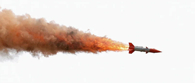 Red military missile in flight leaving fiery smoke trail against white sky