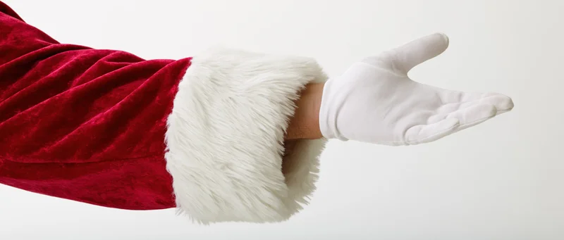 Santa's gloved hand extended with open palm against white background