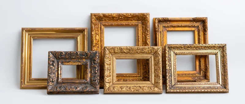 Six antique gold picture frames arranged flat against a plain white background