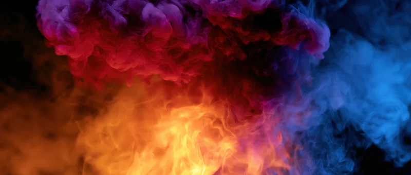 Swirling colored smoke and flame wisps filling the frame