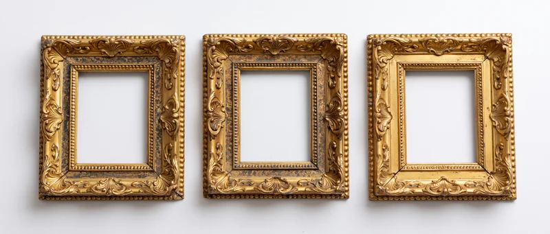 Three antique gilded picture frames arranged side by side on a white wall