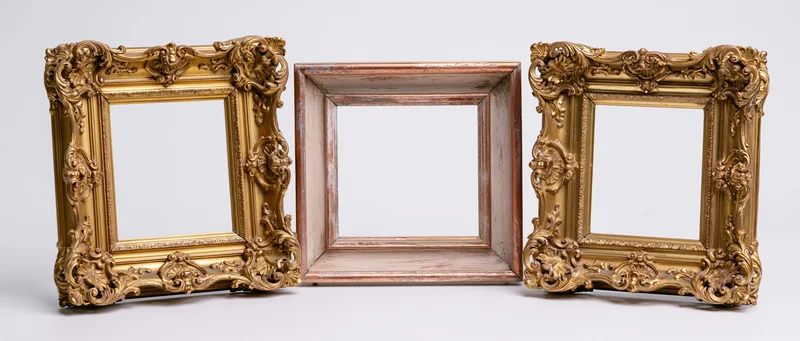 Three antique ornate gold and wooden picture frames arranged side by side on white background