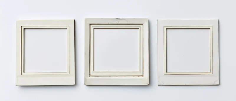Three blank instant film photo frames arranged side by side on white surface