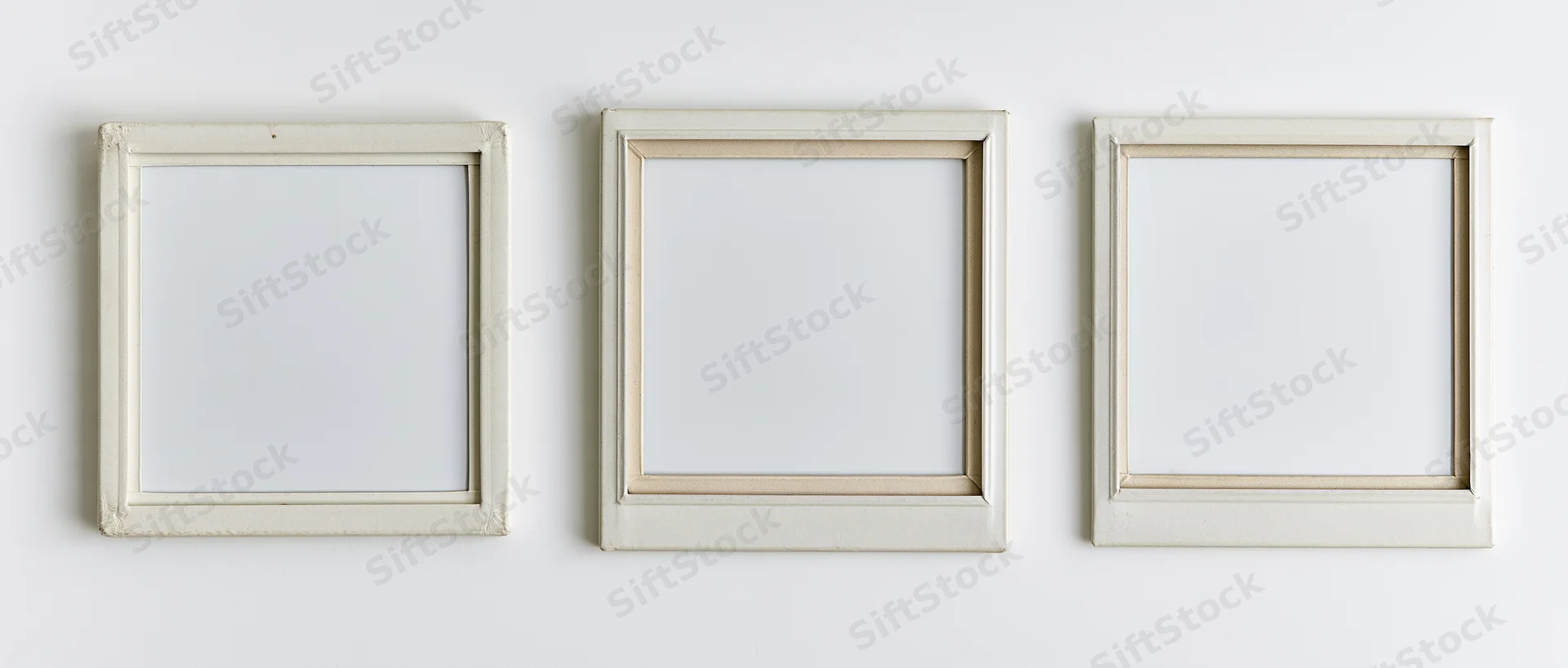 Three blank instant film photo frames arranged horizontally on a white surface