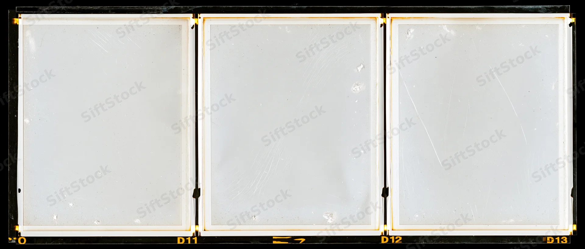 Three blank overexposed medium format film frames arranged in a row on a contact sheet