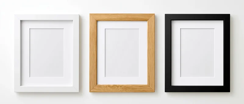 Three empty picture frames with white mats arranged side by side on a white wall