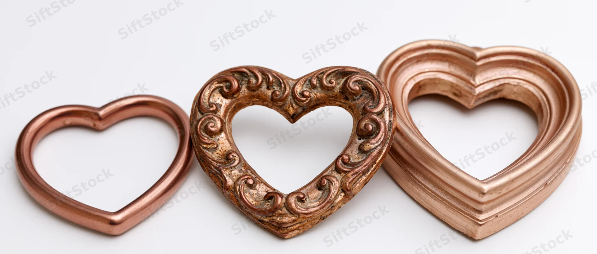 Three heart-shaped decorative frames arranged side by side on white background