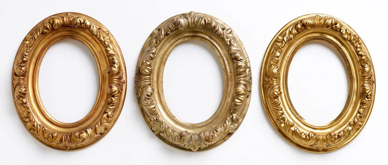 Three ornate gilded oval picture frames arranged side by side on white background