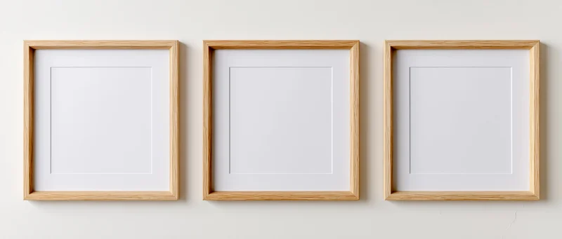 Three light oak wooden picture frames with blank white mats mounted on a plain wall