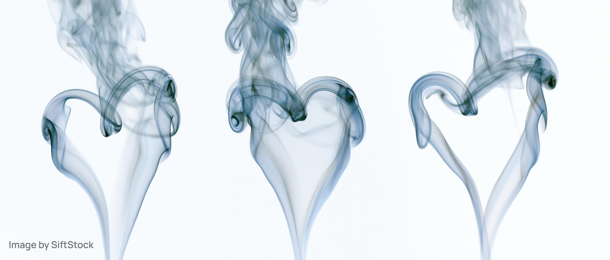 Three smoke plumes curling into heart shapes against a white background
