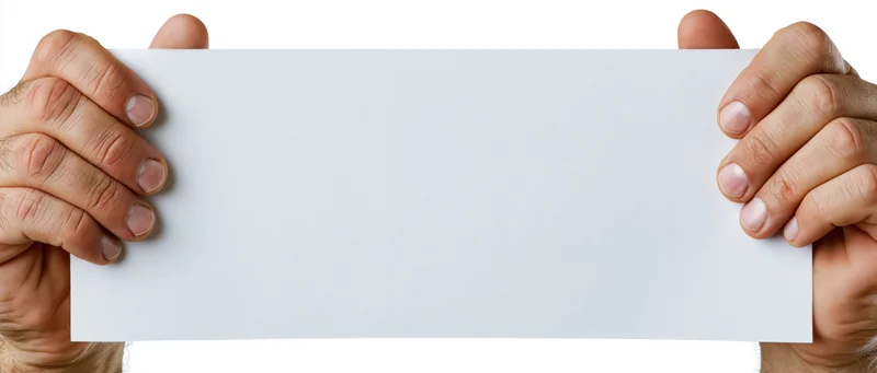 Adult male hands gripping edges of a blank white paper sign against white background