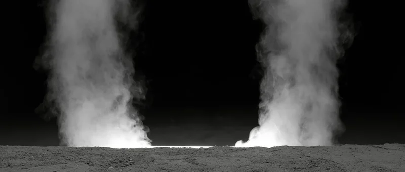 Two columns of white smoke rising from a rough ground surface at night