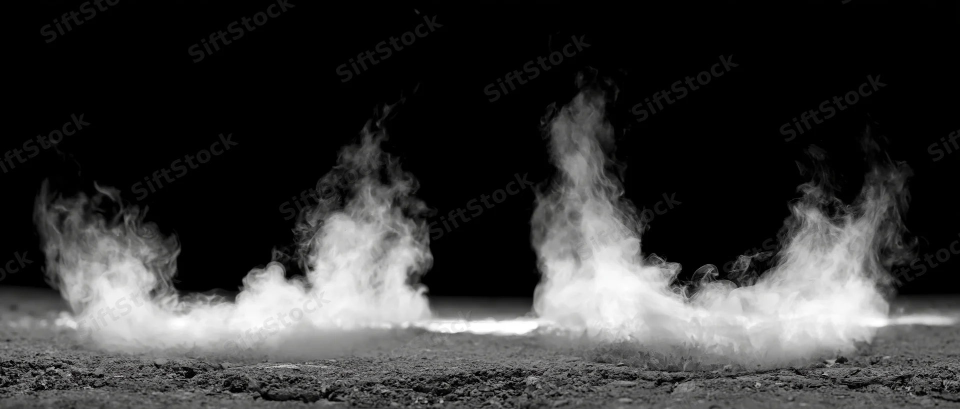 White smoke rising in columns from rough ground against black background