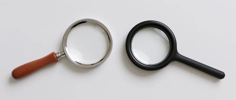 Two magnifying glasses side by side on white surface