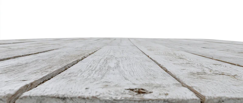 Weathered white-painted wooden floor planks receding into the distance with copyspace above