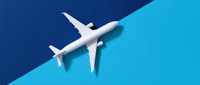 White commercial airplane model on blue gradient background