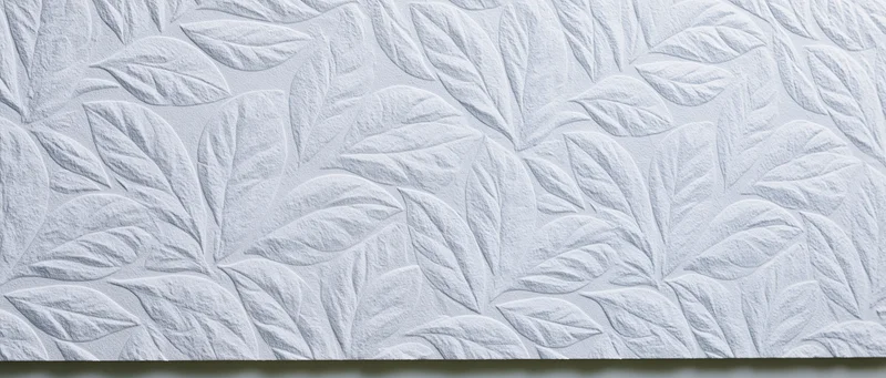 White embossed wall panel with repeating leaf pattern for interior decor