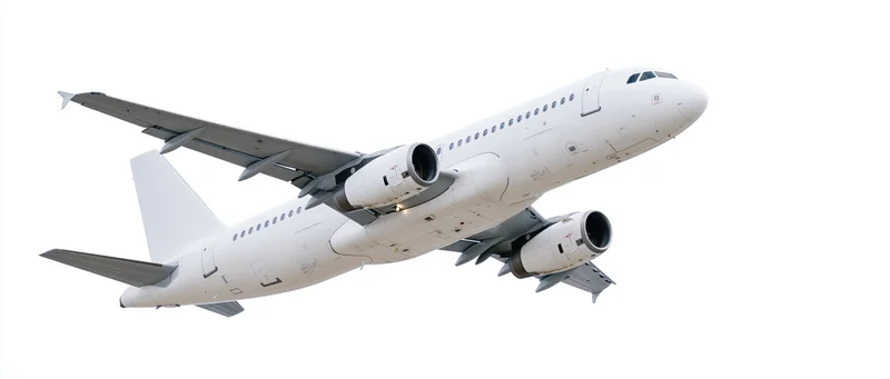 White unmarked commercial passenger jet climbing in midair against plain background