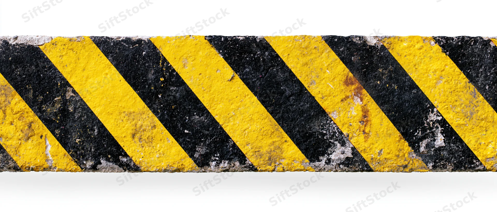 Worn hazard warning stripe band with diagonal black and yellow paint on concrete barrier isolated on white