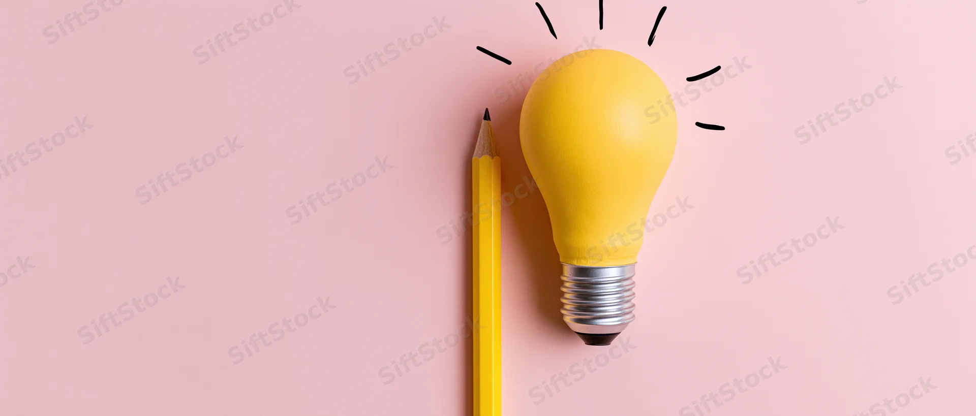 Yellow lightbulb and pencil arranged upright on pink surface symbolizing idea generation