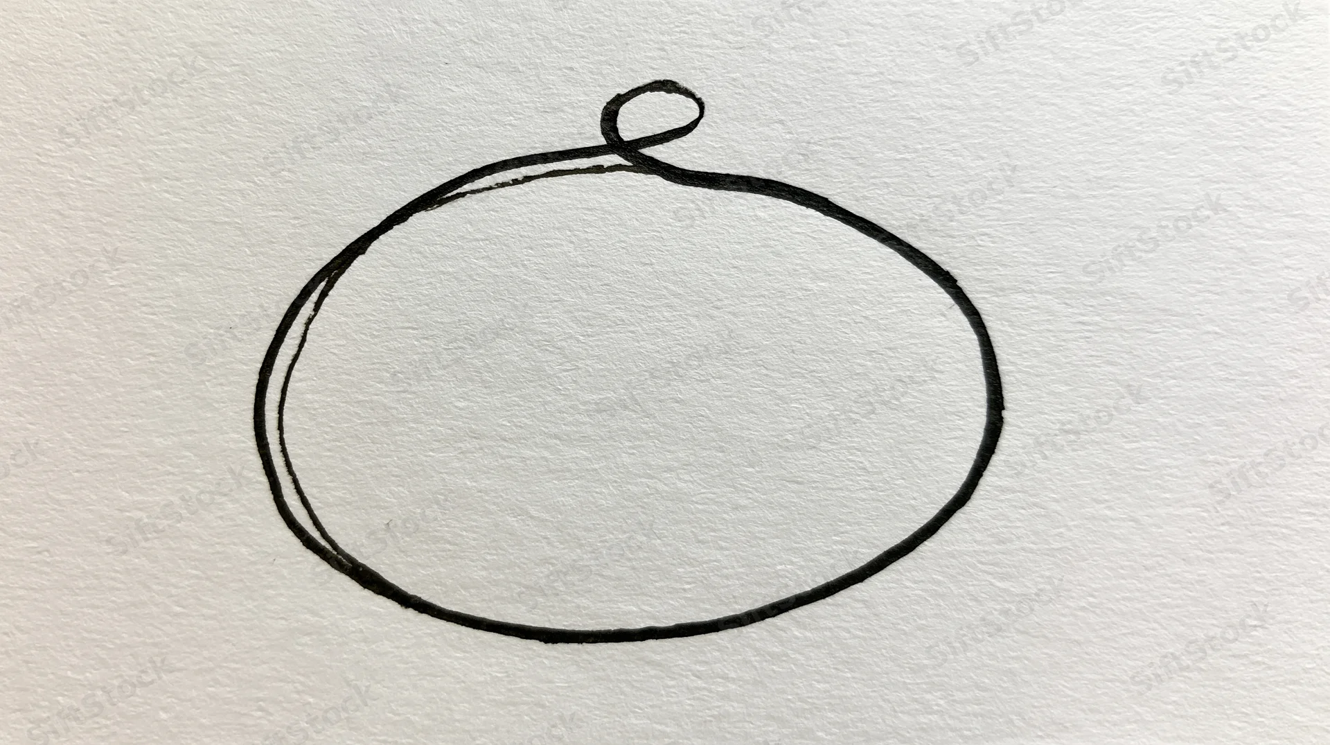 Hand-drawn oval shape outlined in dark ink on textured white paper