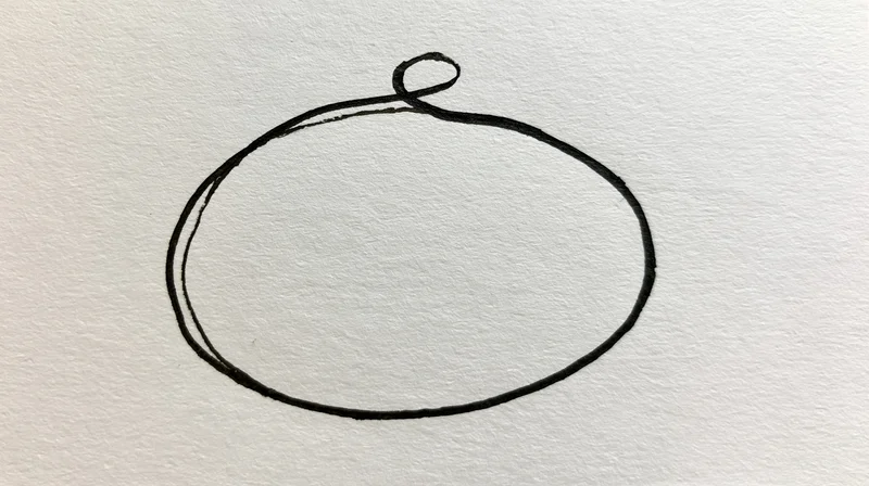 Hand-drawn oval shape outlined in dark ink on textured white paper