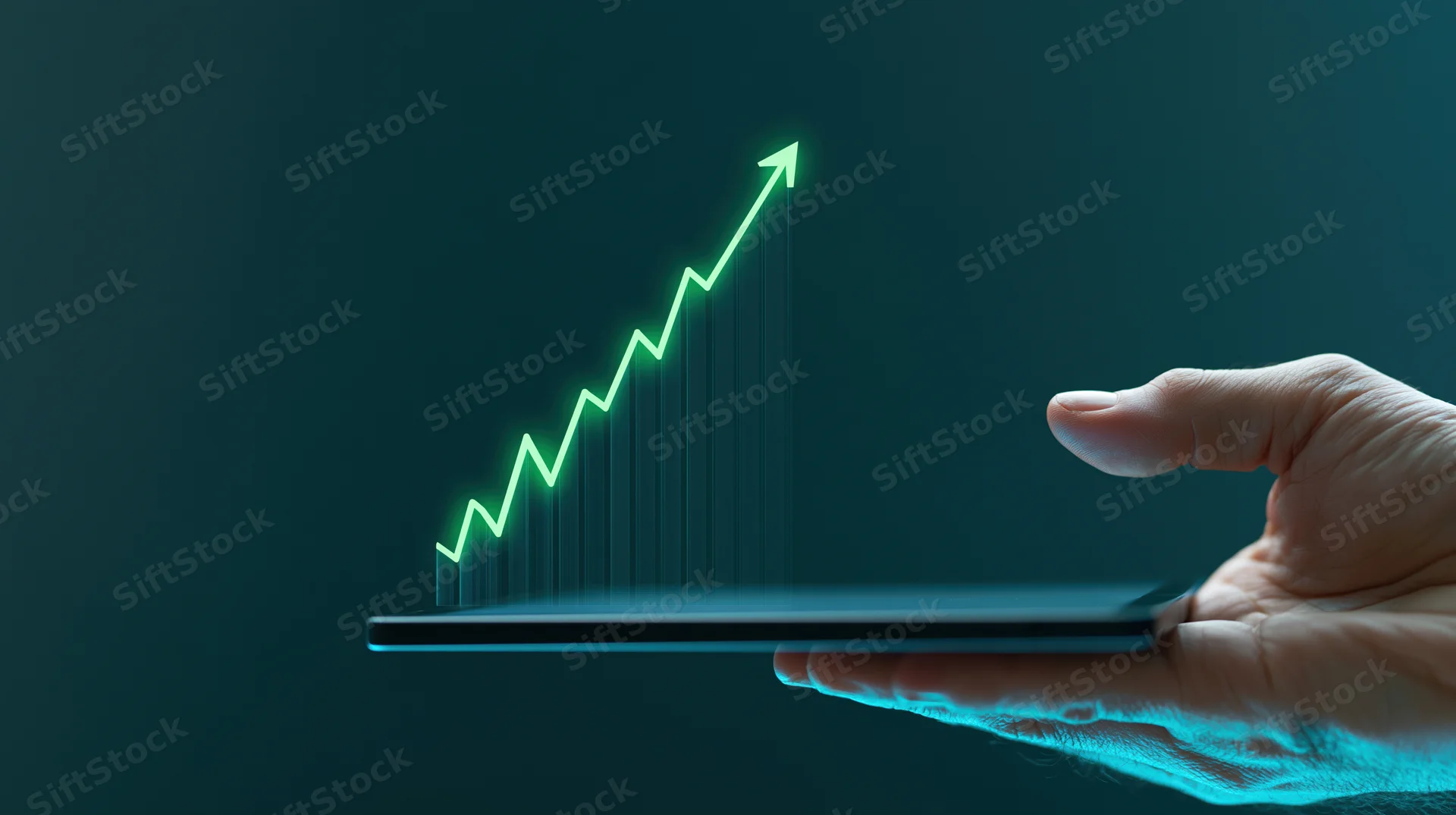 Hand holding tablet with glowing green upward graph emerging from screen