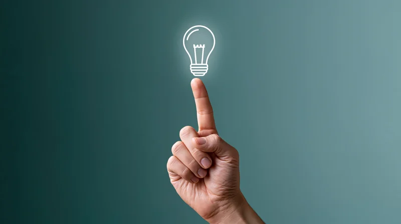 Hand pointing upward toward a glowing lightbulb symbol on a teal background