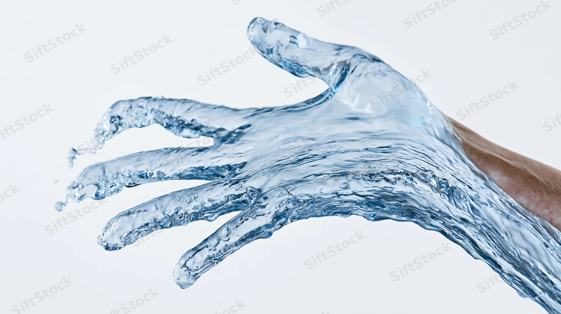Hand formed from flowing water against white background