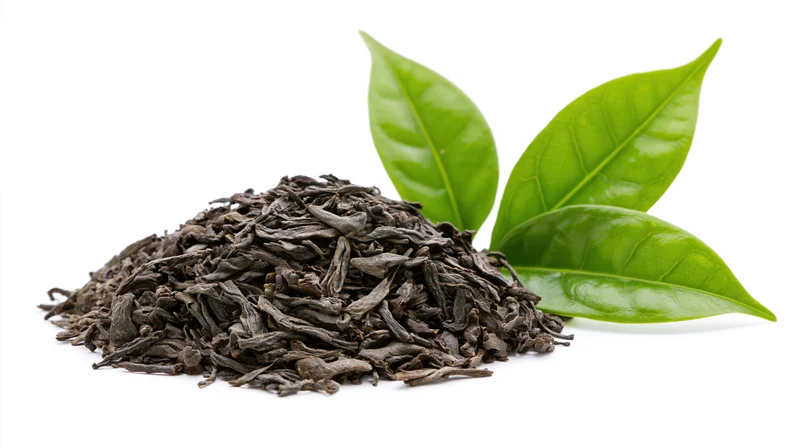 Pile of dried black tea leaves with fresh green tea leaves on white background