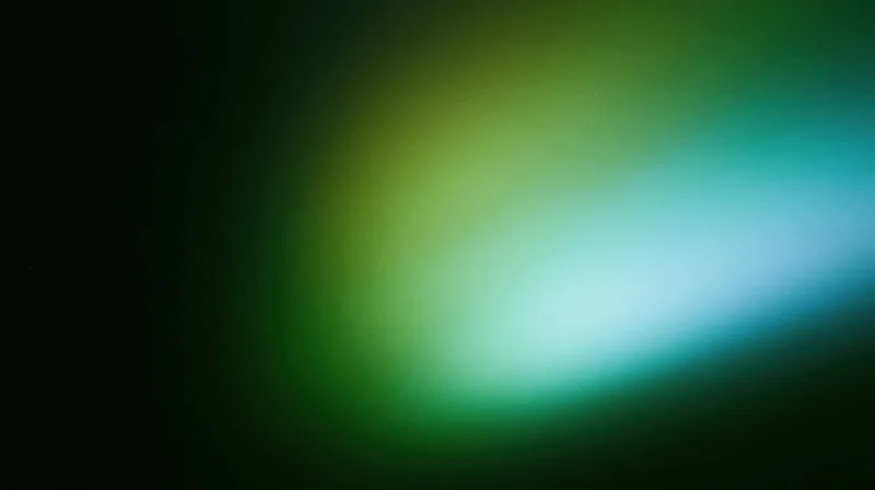 Abstract blurred gradient of green and blue light against dark background with soft glow and copyspace