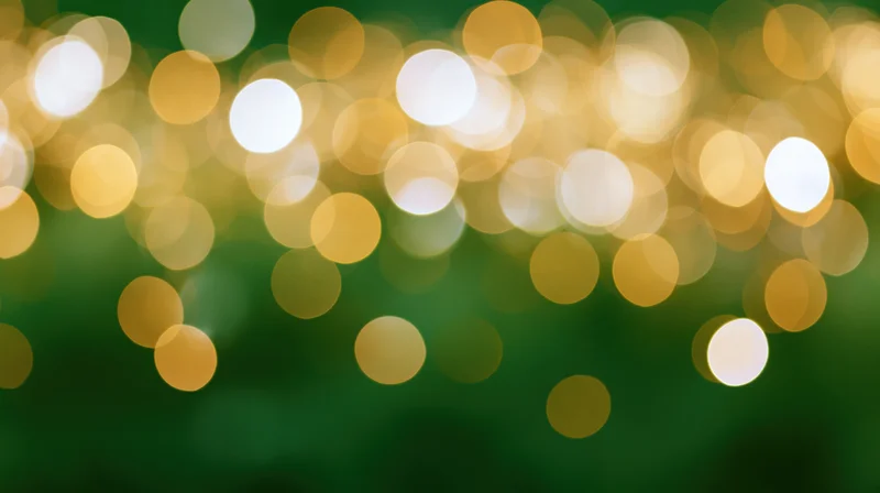 Abstract bokeh lights in golden and white tones against a green background