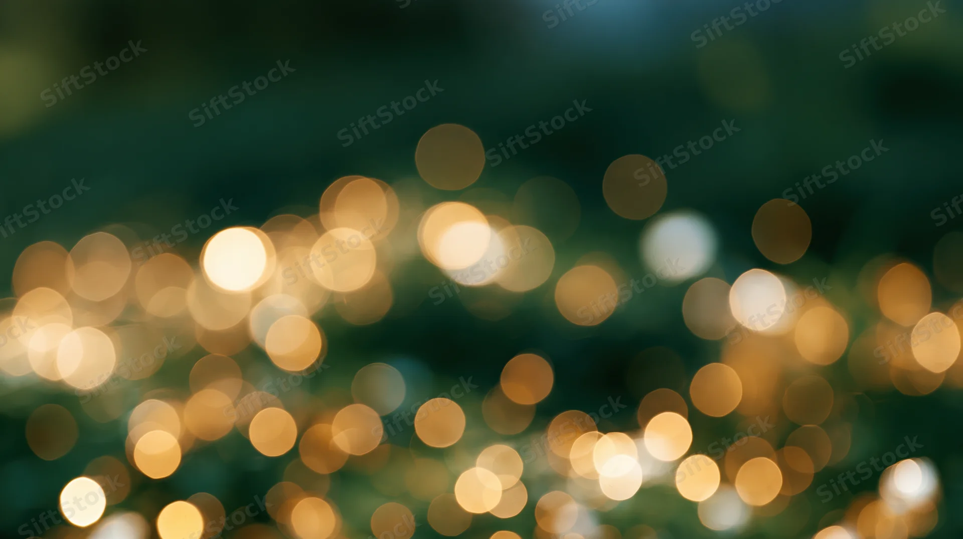 Blurred golden and white lights scattered across a dark background creating a festive bokeh effect