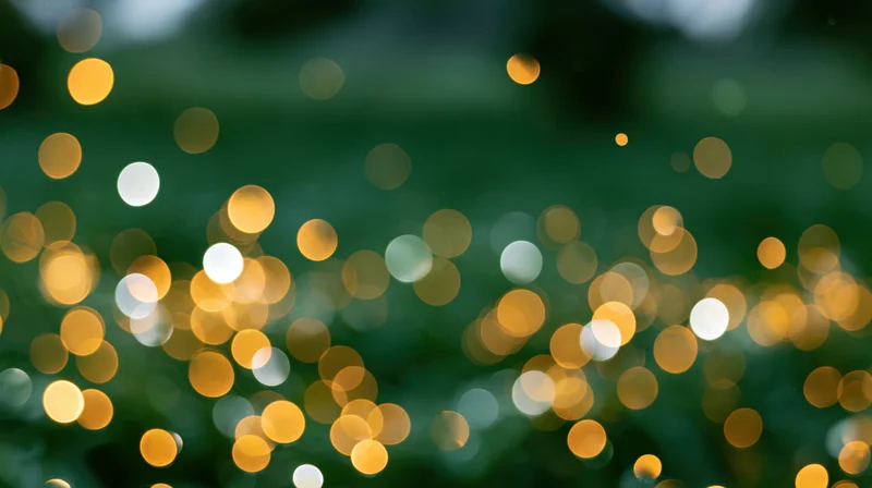 Blurred golden and white lights scattered across a dark green natural background
