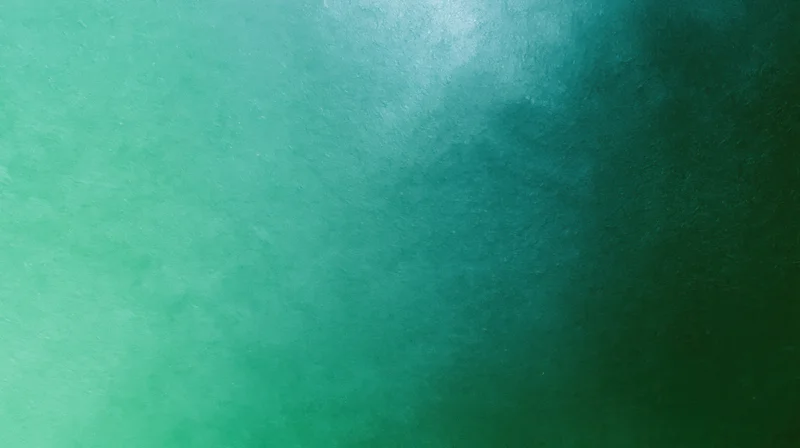 Smooth green to teal gradient background with grainy texture
