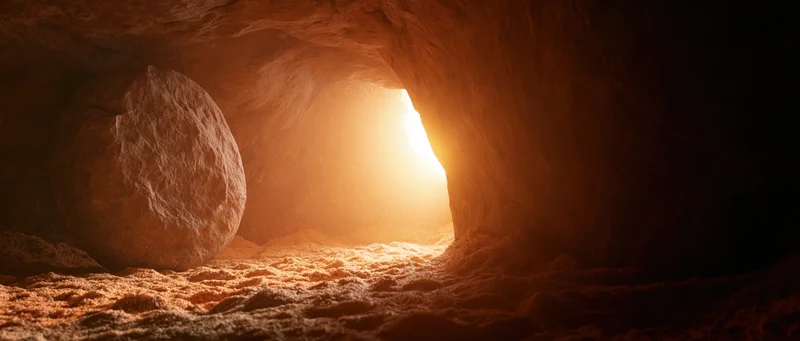 Ancient tomb entrance with large round stone blocking the doorway, illuminated by sunlight from outside