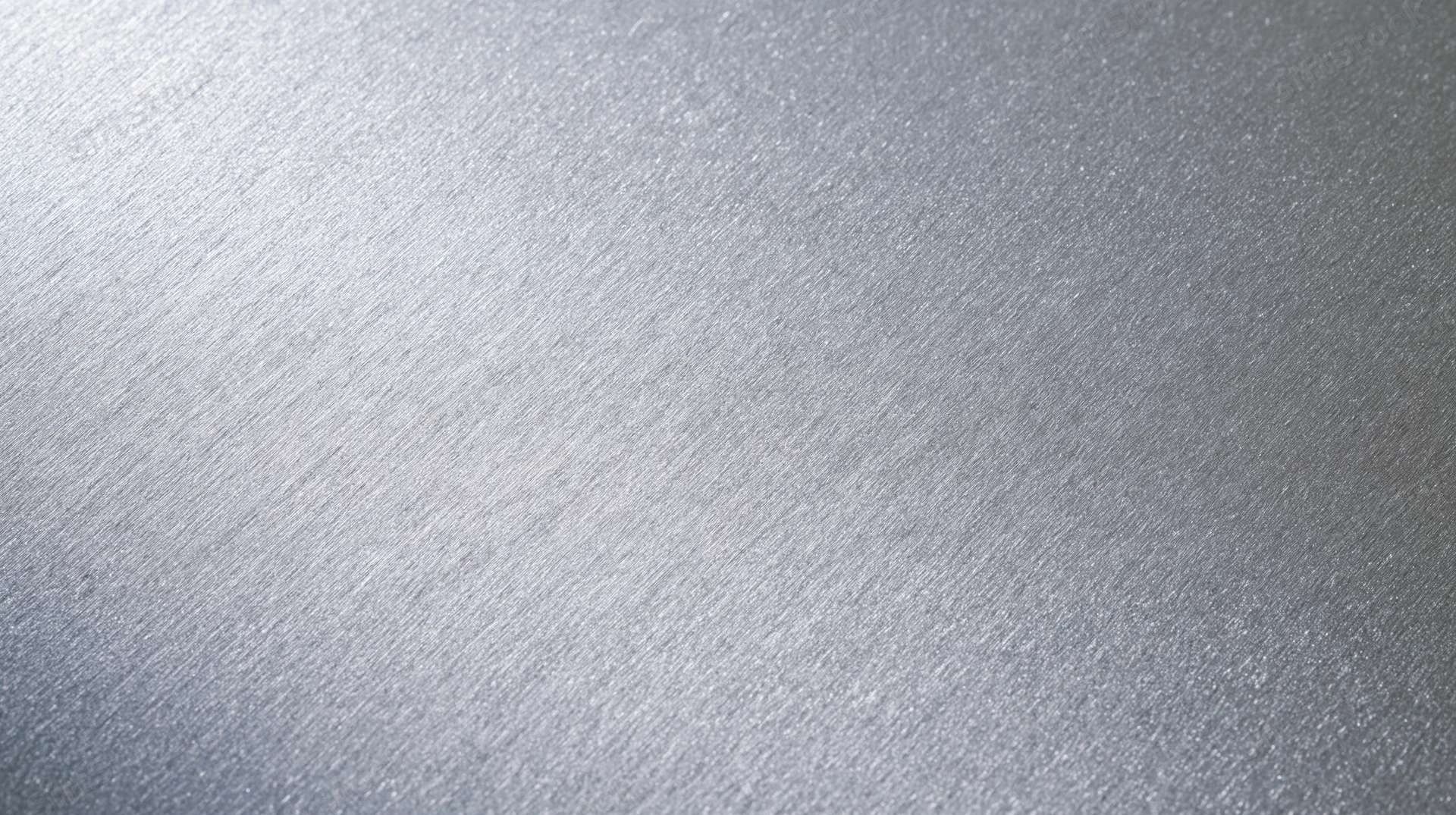 Close-up of brushed aluminum surface with textured grain and light gradient