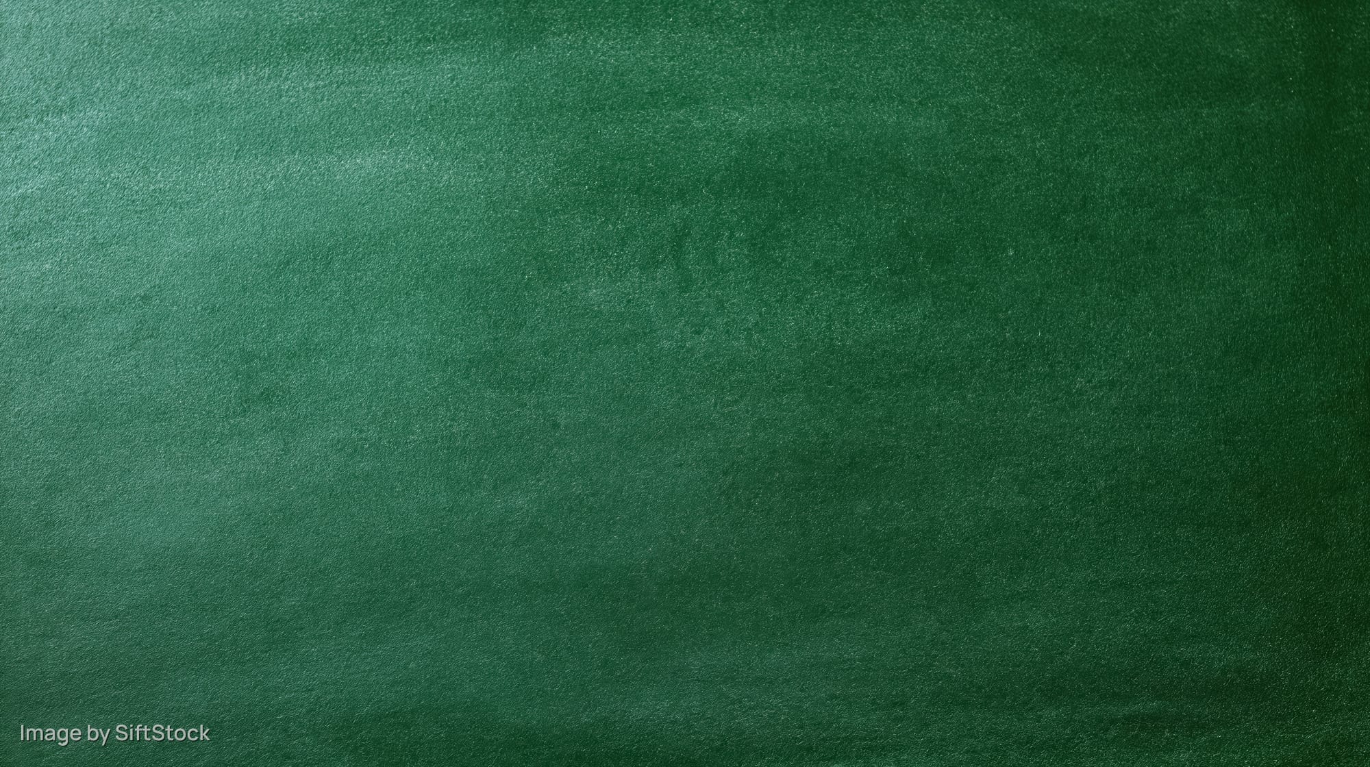 Close-up of a dark green chalkboard surface with textured matte finish