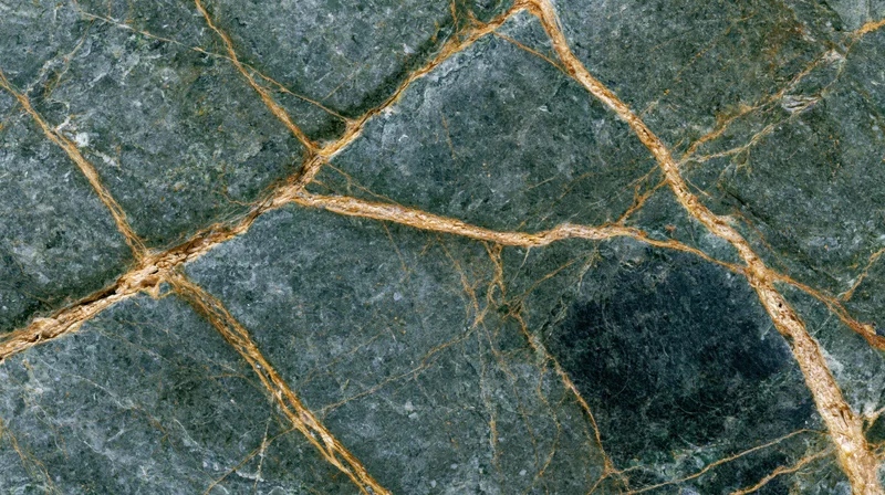 Close-up of polished dark green marble slab with gold veining