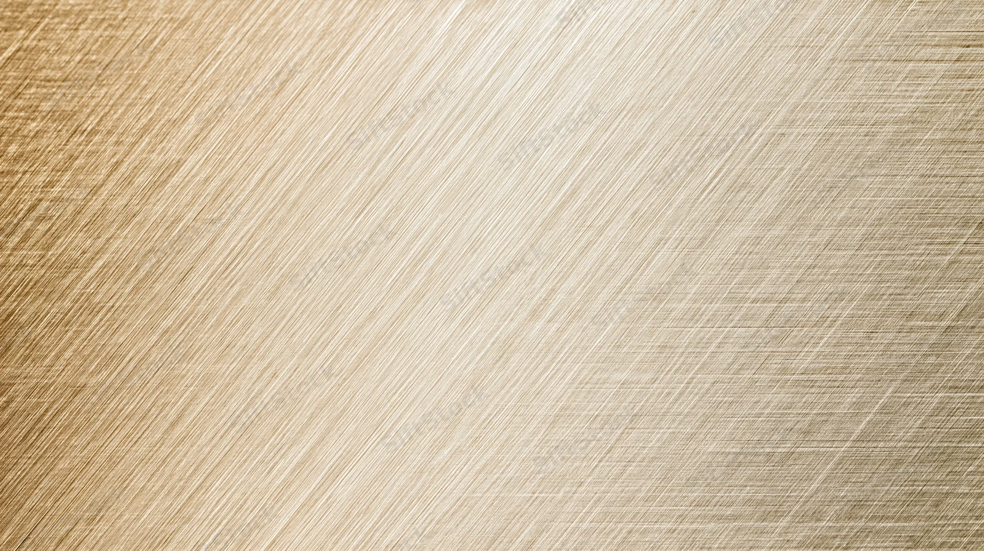 Close-up of a brushed metallic surface with diagonal ribbed texture and warm golden tone