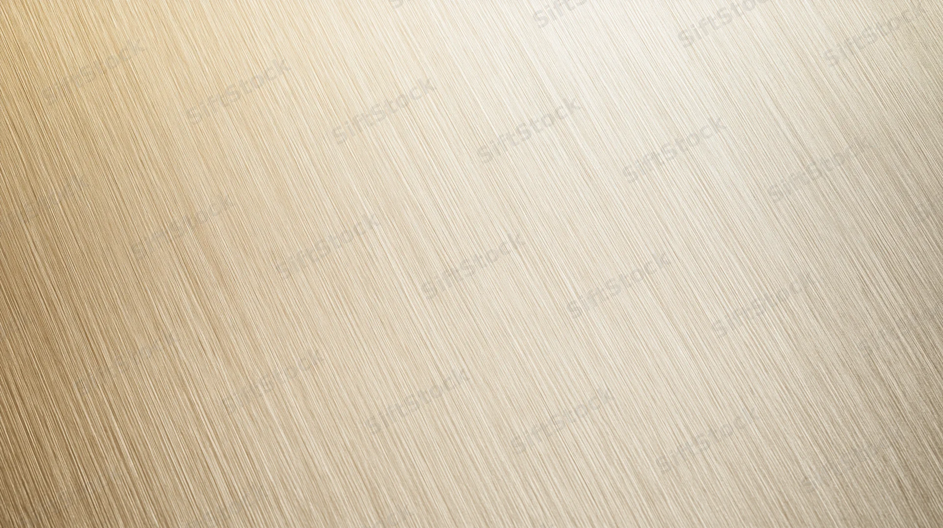 Close-up of a brushed metallic surface with fine diagonal ribs and warm golden tone