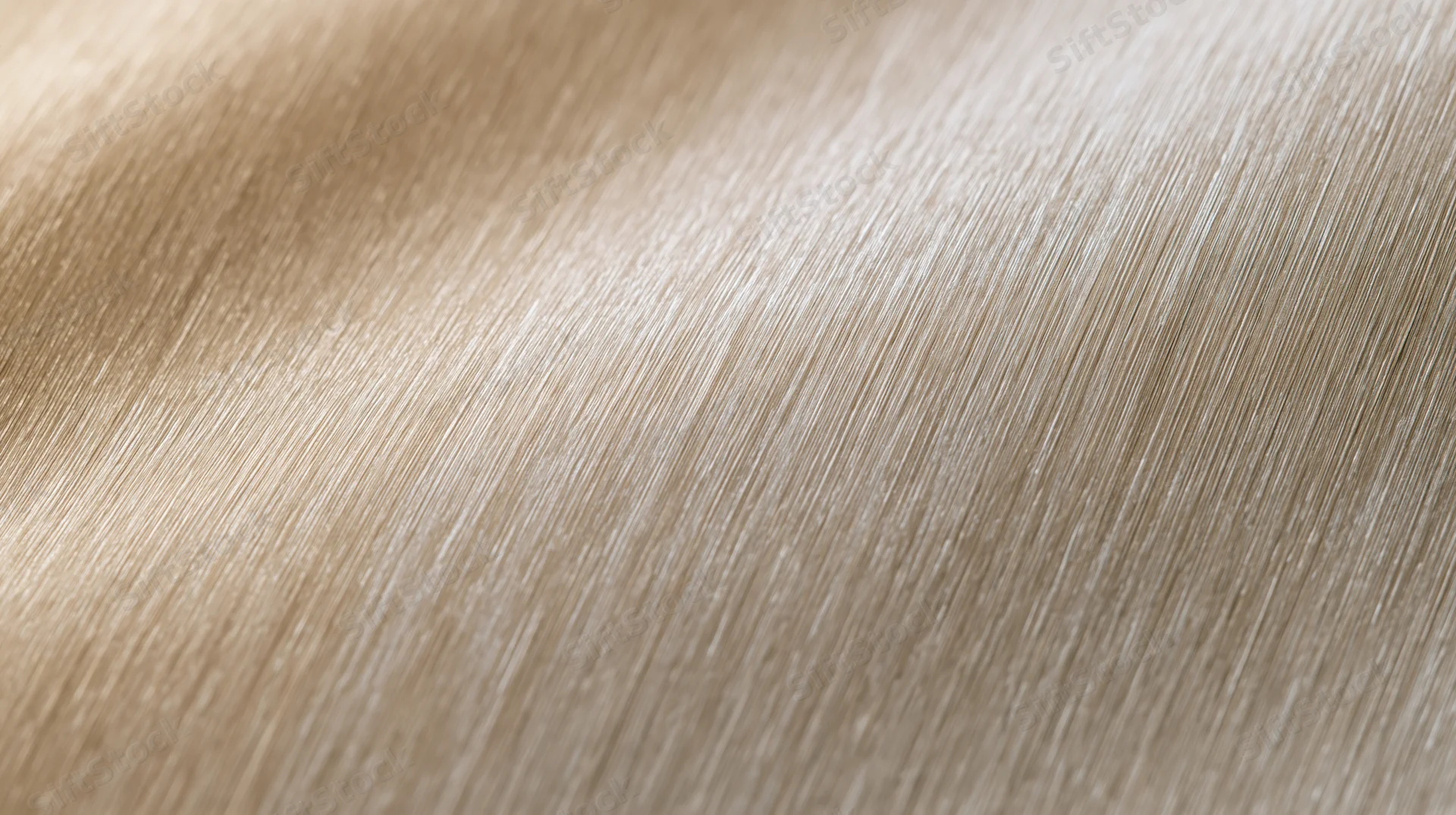 Close-up of a ribbed metallic surface with fine vertical texture and soft light reflection