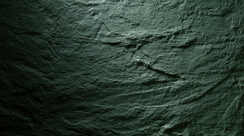 Close-up of rough textured concrete wall surface with dark gray tones and subtle lighting variations