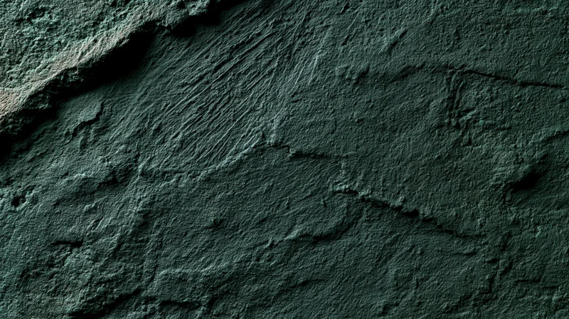 Close-up of rough textured concrete wall surface with cracks and uneven finish