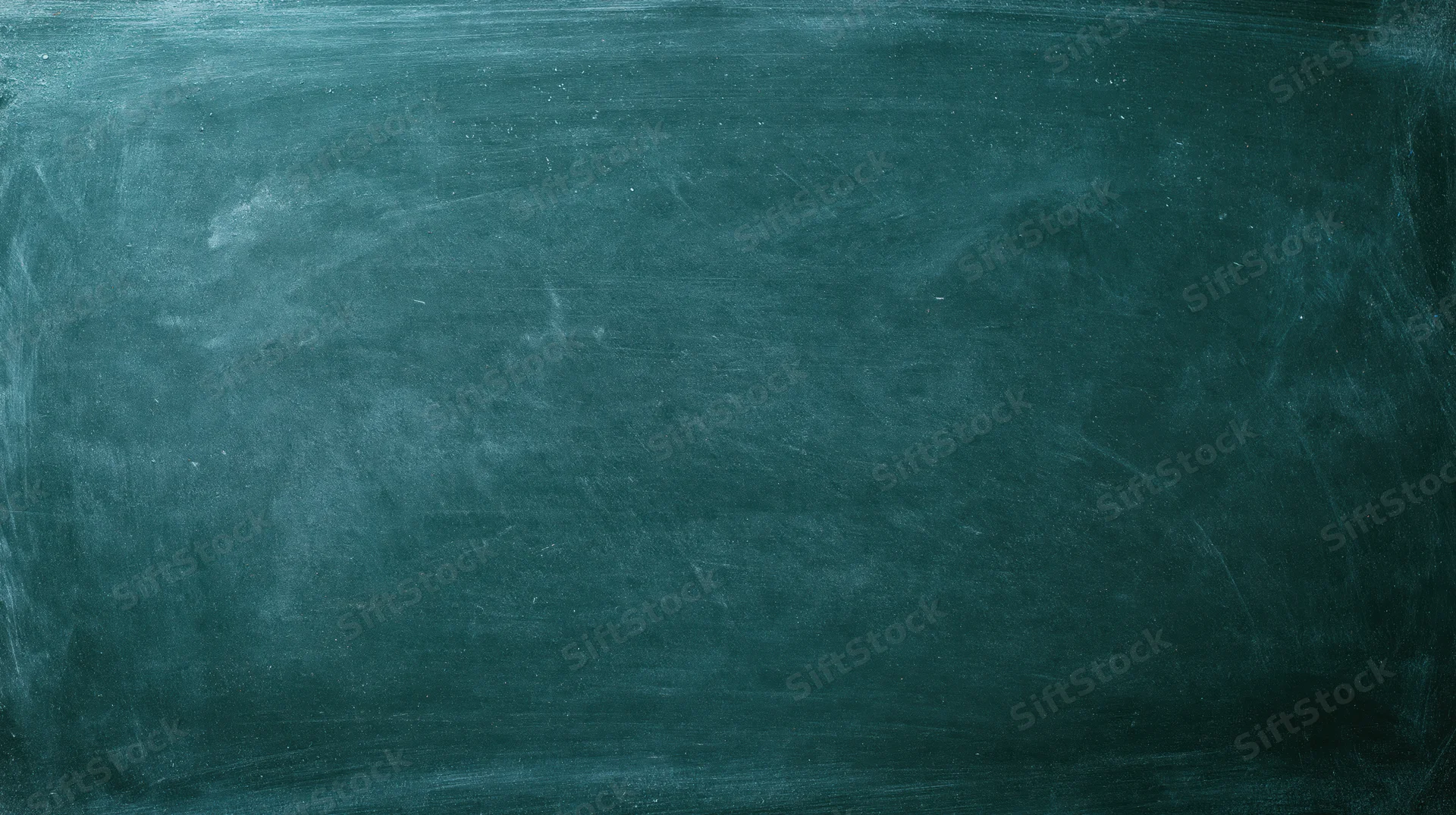 Close-up of a worn dark green chalkboard surface with smudged chalk residue and scratches